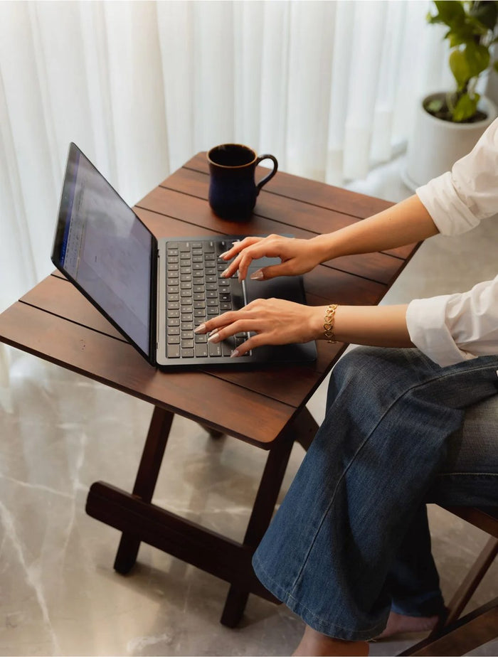 Walnut folding table in use as a desk with a laptop