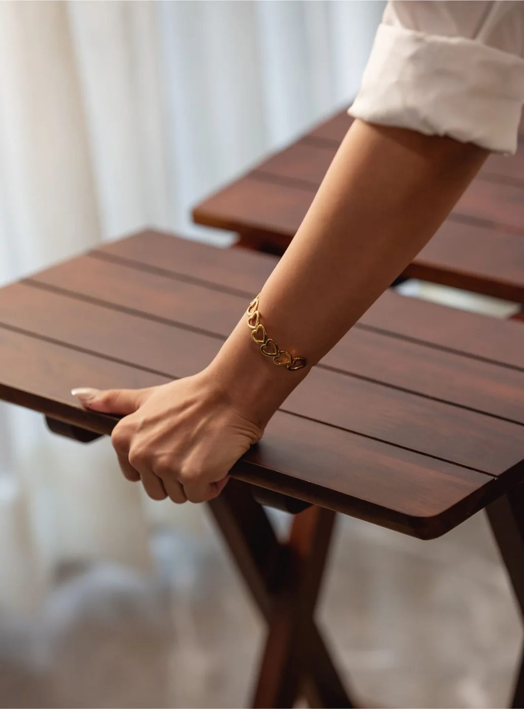 Carrying the walnut folding table by its slatted top